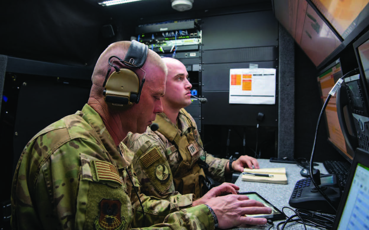 Master Sergeant Paul Thompson, left, 621st Contingency Response Support Squadron (CRSS) operations standards and evaluation superintendent, and Technical Sergeant Kevin Koenig, 621st CRSS tactical radio communications section chief, provide communication from Nomad GCS Tactical Control Vehicle during exercise on Nellis Air Force Base, Nevada, September 3, 2020 (U.S. Air Force/Cory D. Payne)